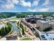 Aerial view of community with lake, amphitheater, and shopping center at 5195 Oaks Landing Ct, Sugar Hill, GA 30518
