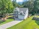Spacious two-story home boasts a manicured lawn and attached two-car garage at 5195 Oaks Landing Ct, Sugar Hill, GA 30518