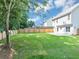 Backyard featuring lush grass and a wooden privacy fence at 5195 Oaks Landing Ct, Sugar Hill, GA 30518