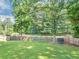 An expansive backyard with a trampoline and a tall, wood privacy fence at 5195 Oaks Landing Ct, Sugar Hill, GA 30518