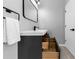 Stylish bathroom vanity with open drawers and sleek fixtures, adjacent to a white door at 5195 Oaks Landing Ct, Sugar Hill, GA 30518