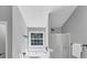 Bathroom with a soaking tub under a window and a glass-enclosed shower at 5195 Oaks Landing Ct, Sugar Hill, GA 30518