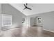 Spacious bedroom with vaulted ceiling, modern fan, and abundant natural light from multiple windows at 5195 Oaks Landing Ct, Sugar Hill, GA 30518