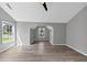 Spacious bedroom with vaulted ceiling, modern fan, and abundant natural light from multiple windows at 5195 Oaks Landing Ct, Sugar Hill, GA 30518