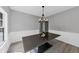 Dining room featuring modern light fixture and wainscoting at 5195 Oaks Landing Ct, Sugar Hill, GA 30518