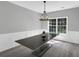 Dining room with modern chandelier and a window view at 5195 Oaks Landing Ct, Sugar Hill, GA 30518