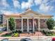 City of Sugar Hill building showcasing traditional architecture and American flags at 5195 Oaks Landing Ct, Sugar Hill, GA 30518
