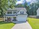 Beautiful two-story home with a well-kept lawn and attached garage at 5195 Oaks Landing Ct, Sugar Hill, GA 30518