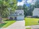 Beautiful two-story home featuring a well-maintained lawn and attached two car garage at 5195 Oaks Landing Ct, Sugar Hill, GA 30518
