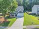 Charming two-story home boasts a manicured lawn and a welcoming front porch at 5195 Oaks Landing Ct, Sugar Hill, GA 30518
