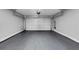 Spacious garage with gray epoxy flooring and automatic door opener at 5195 Oaks Landing Ct, Sugar Hill, GA 30518