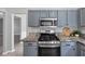 Modern kitchen featuring granite countertops and stainless steel appliances at 5195 Oaks Landing Ct, Sugar Hill, GA 30518