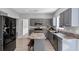 Modern kitchen with stainless steel appliances, a center island, and ample cabinet space at 5195 Oaks Landing Ct, Sugar Hill, GA 30518