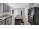 Bright kitchen with stainless steel appliances, gray cabinets, and a center island with seating at 5195 Oaks Landing Ct, Sugar Hill, GA 30518