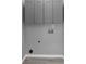 A functional laundry room featuring gray cabinets and hardwood floors at 5195 Oaks Landing Ct, Sugar Hill, GA 30518