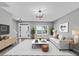A well-lit living room boasts a sleek chandelier and modern furnishings at 5195 Oaks Landing Ct, Sugar Hill, GA 30518