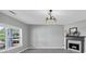 Modern living room with fireplace and mantel and a large window at 5195 Oaks Landing Ct, Sugar Hill, GA 30518
