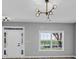 Bright living room featuring a modern chandelier and a minimalist design at 5195 Oaks Landing Ct, Sugar Hill, GA 30518