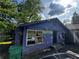 Modest blue single story home adorned with festive patriotic decorations on a sunny day at 6733 Old Covington Rd, Lithonia, GA 30058