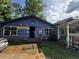 Single-story home with light blue siding and barred windows at 6733 Old Covington Rd, Lithonia, GA 30058