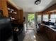 Kitchen with black appliances and a back entrance with a metal security door at 6733 Old Covington Rd, Lithonia, GA 30058
