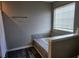 Bright bathroom featuring a tub with tile surround, a window, and vinyl flooring at 842 Shoals Ct, Atlanta, GA 30349