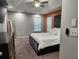 Bright primary bedroom features a stylish headboard, modern furnishings, and recessed lighting at 842 Shoals Ct, Atlanta, GA 30349