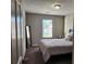 Comfortable bedroom with neutral colors, a window, and carpet at 842 Shoals Ct, Atlanta, GA 30349