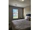 Cozy bedroom featuring natural light from a window and neutral decor at 842 Shoals Ct, Atlanta, GA 30349