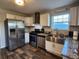 Updated kitchen with stainless steel appliances, granite counters, and a farmhouse sink at 842 Shoals Ct, Atlanta, GA 30349