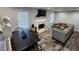 This living room has a fireplace, modern sofa, window and wood-look flooring at 842 Shoals Ct, Atlanta, GA 30349