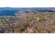 An expansive aerial view of the area around the home reveals mature trees and quiet surroundings at 1337 Fairfield Dr, Lilburn, GA 30047