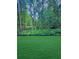 Lush green lawn and private wooded backyard offers a serene and natural setting at 1337 Fairfield Dr, Lilburn, GA 30047