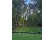 Lush backyard features a wooded view, creating a peaceful and private outdoor space at 1337 Fairfield Dr, Lilburn, GA 30047