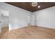 Bedroom featuring hardwood floors, wooden slat ceiling, modern ceiling fan, closet and multiple doorways at 1337 Fairfield Dr, Lilburn, GA 30047