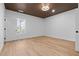 Bedroom featuring hardwood floors, wooden slat ceiling, modern lighting and a large window at 1337 Fairfield Dr, Lilburn, GA 30047