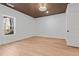Bedroom featuring hardwood floors, wooden slat ceiling, modern lighting and a large window at 1337 Fairfield Dr, Lilburn, GA 30047