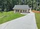Charming single-story home featuring a new driveway, front porch, and a well-manicured lawn at 1337 Fairfield Dr, Lilburn, GA 30047