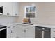 Beautiful kitchen with white cabinets, quartz countertops, stainless steel appliances, and black hardware at 1337 Fairfield Dr, Lilburn, GA 30047