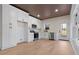 Modern kitchen featuring white cabinets, stainless steel appliances, and beautiful hardwood floors at 1337 Fairfield Dr, Lilburn, GA 30047