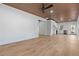 Open living space with hardwood floors, modern lighting, and a view into the kitchen area at 1337 Fairfield Dr, Lilburn, GA 30047