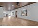 Open living space with hardwood floors, modern lighting, and a view into the kitchen area at 1337 Fairfield Dr, Lilburn, GA 30047