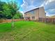 The spacious backyard has a well-maintained lawn and is enclosed by a wooden fence for added privacy at 171 Shaker Hollow Drive Dr, Mcdonough, GA 30253