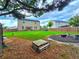 A backyard with a patio, a two-story home with solar panels, and a green lawn at 171 Shaker Hollow Drive Dr, Mcdonough, GA 30253