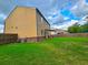 A spacious green backyard with patio seating, a two-story home, and a wooden fence at 171 Shaker Hollow Drive Dr, Mcdonough, GA 30253