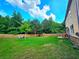This backyard features a lush lawn, fire pit, and patio area, providing a great space for relaxation and entertainment at 171 Shaker Hollow Drive Dr, Mcdonough, GA 30253