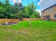 This expansive backyard features lush grass, a fire pit, and a patio with seating, perfect for outdoor gatherings at 171 Shaker Hollow Drive Dr, Mcdonough, GA 30253