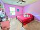 Bright bedroom with vivid pink walls, a comfortable bed, and ample space for personal touches at 171 Shaker Hollow Drive Dr, Mcdonough, GA 30253