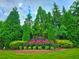 The Farris Community is an eye-catching sight with green trees, flower beds, and manicured shrubbery at 171 Shaker Hollow Drive Dr, Mcdonough, GA 30253