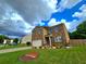 Two-story home featuring a brick facade, attached two-car garage, and landscaped front yard at 171 Shaker Hollow Drive Dr, Mcdonough, GA 30253